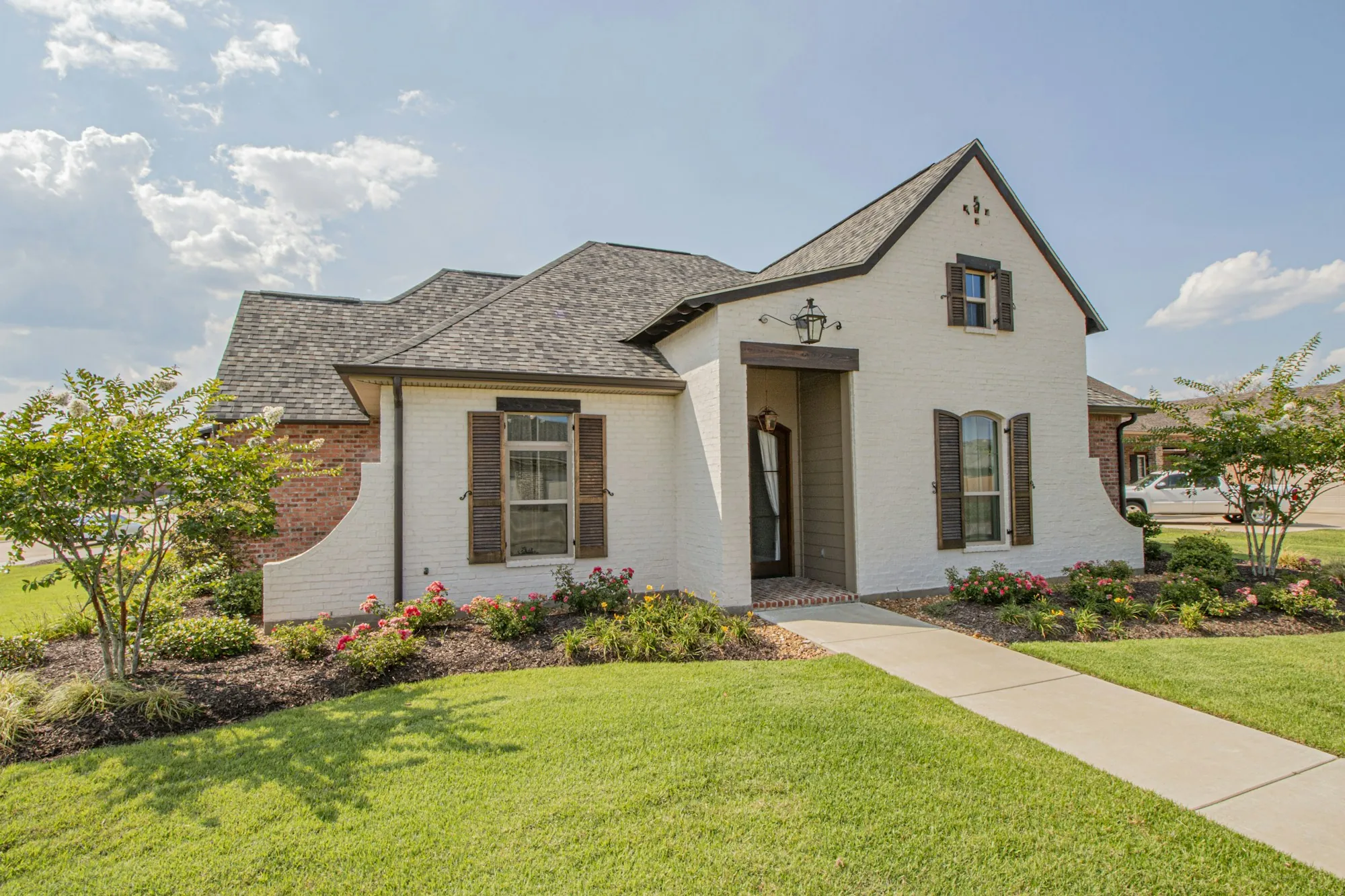 Cream-colored house with a landscaped yard