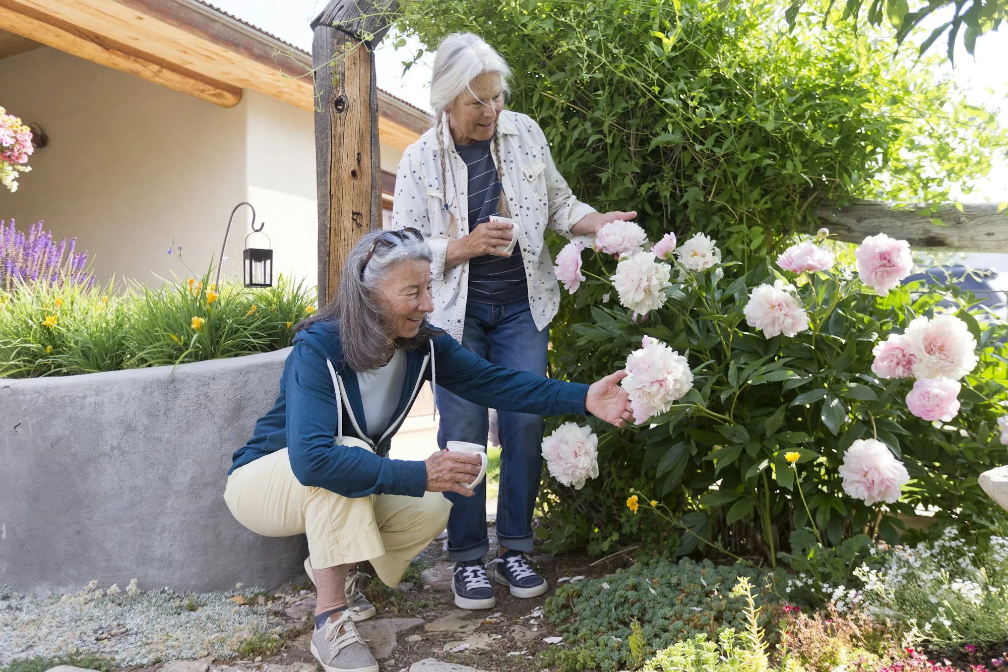 Older women tending flowers in a garden